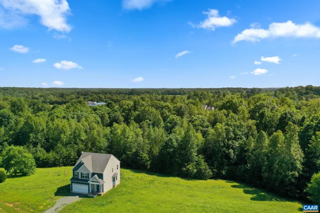 a backyard of a house with lots of green space and garden