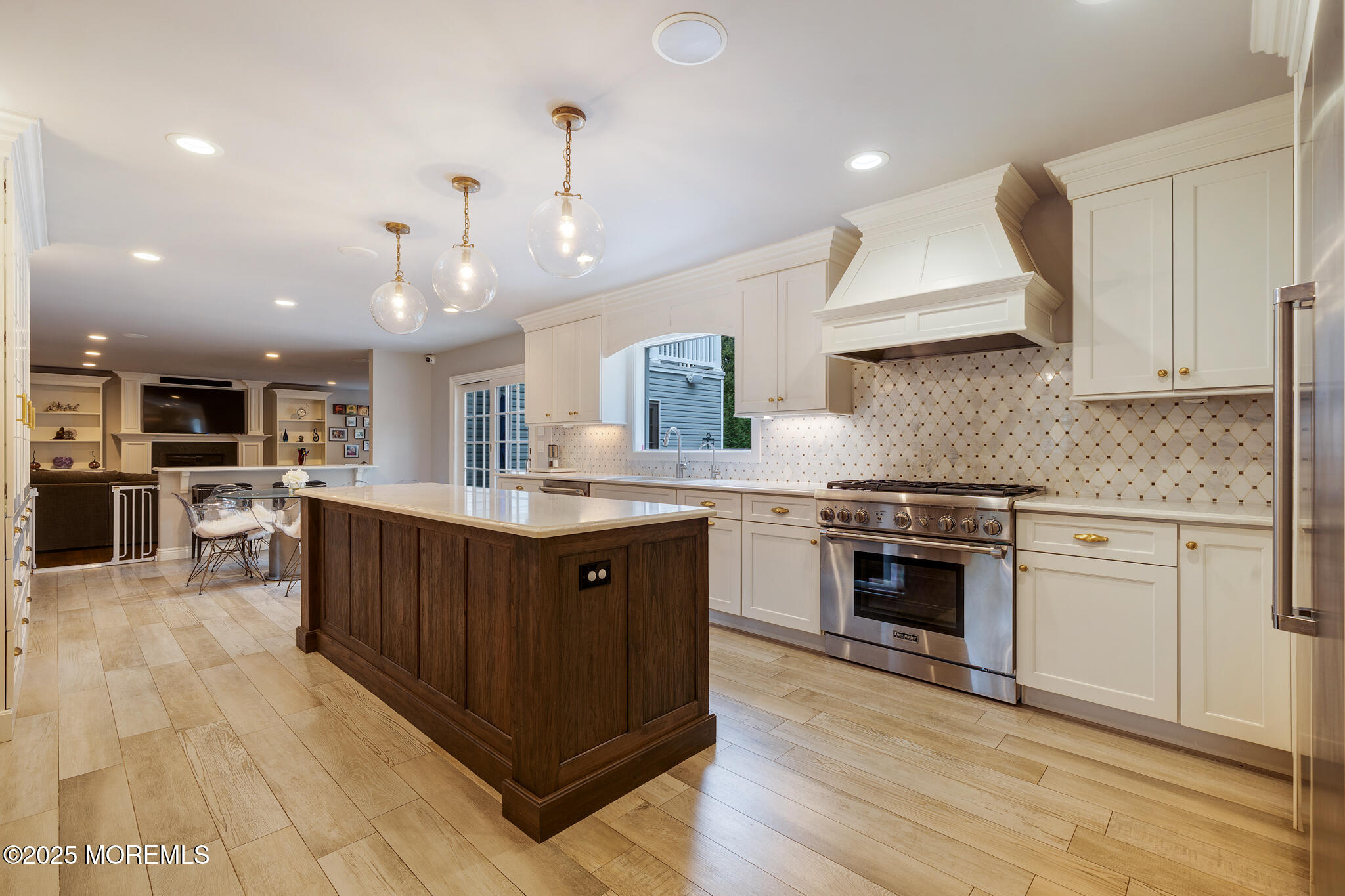 a kitchen with stainless steel appliances granite countertop a stove a sink dishwasher and a refrigerator with wooden floor