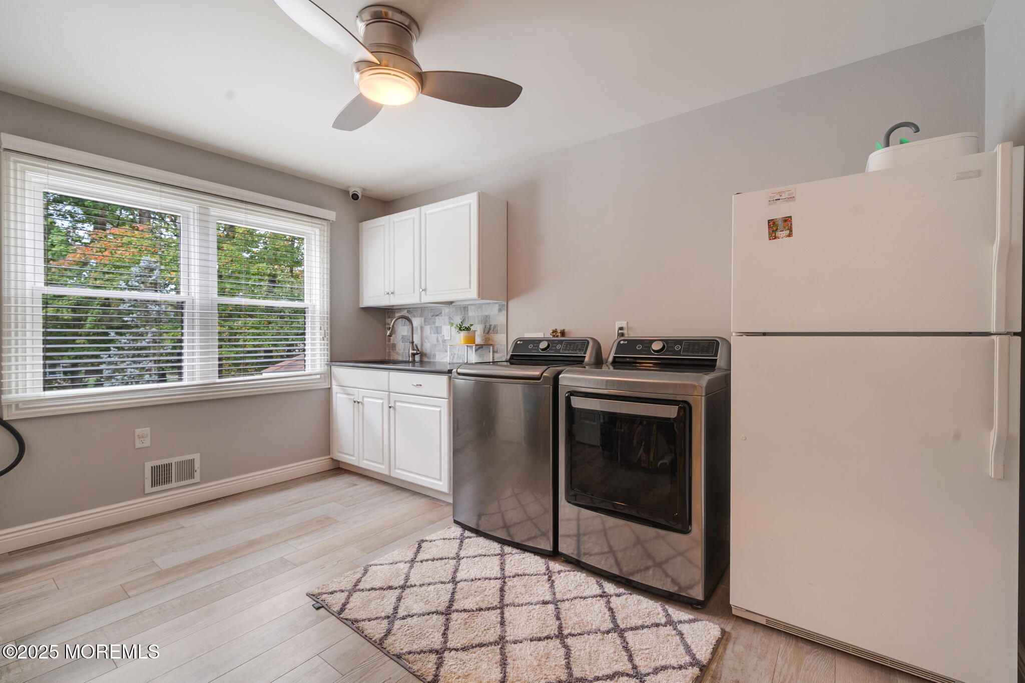 4 Garnet Street Morganville, NJ 07751 - Photo 16 of 70 a kitchen with a refrigerator a stove top oven and cabinets