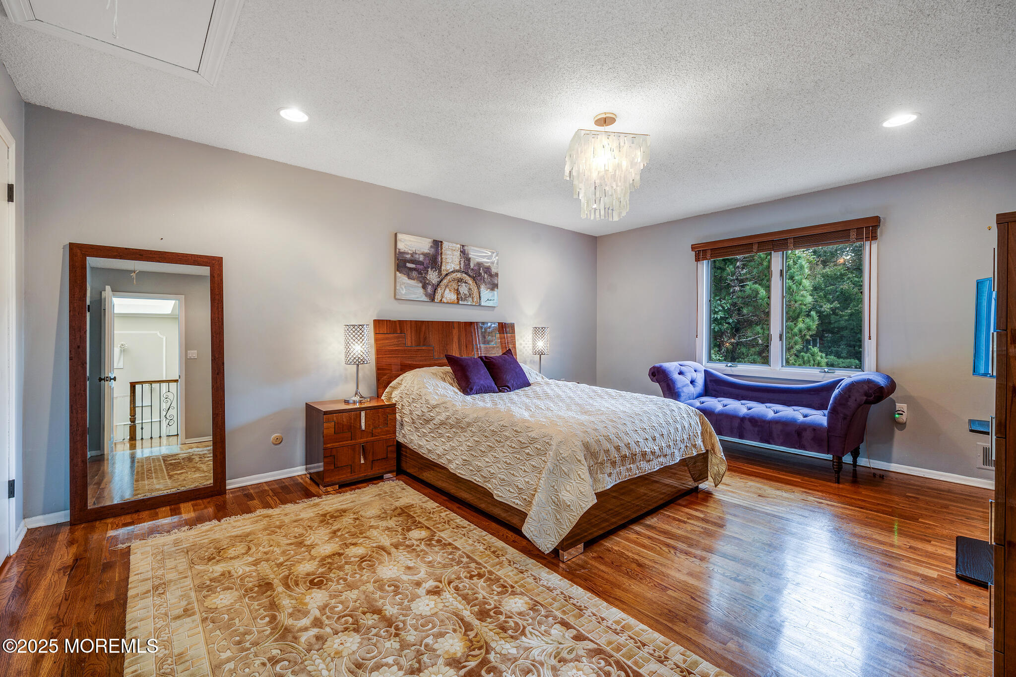4 Garnet Street Morganville, NJ 07751 - Photo 34 of 70 a bedroom with a bed and a chandelier