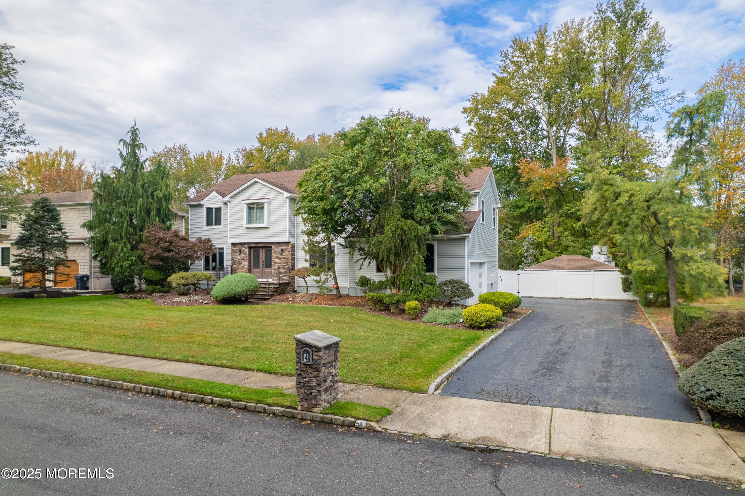 4 Garnet Street Morganville, NJ 07751 - Photo 4 of 70 a front view of a house with garden