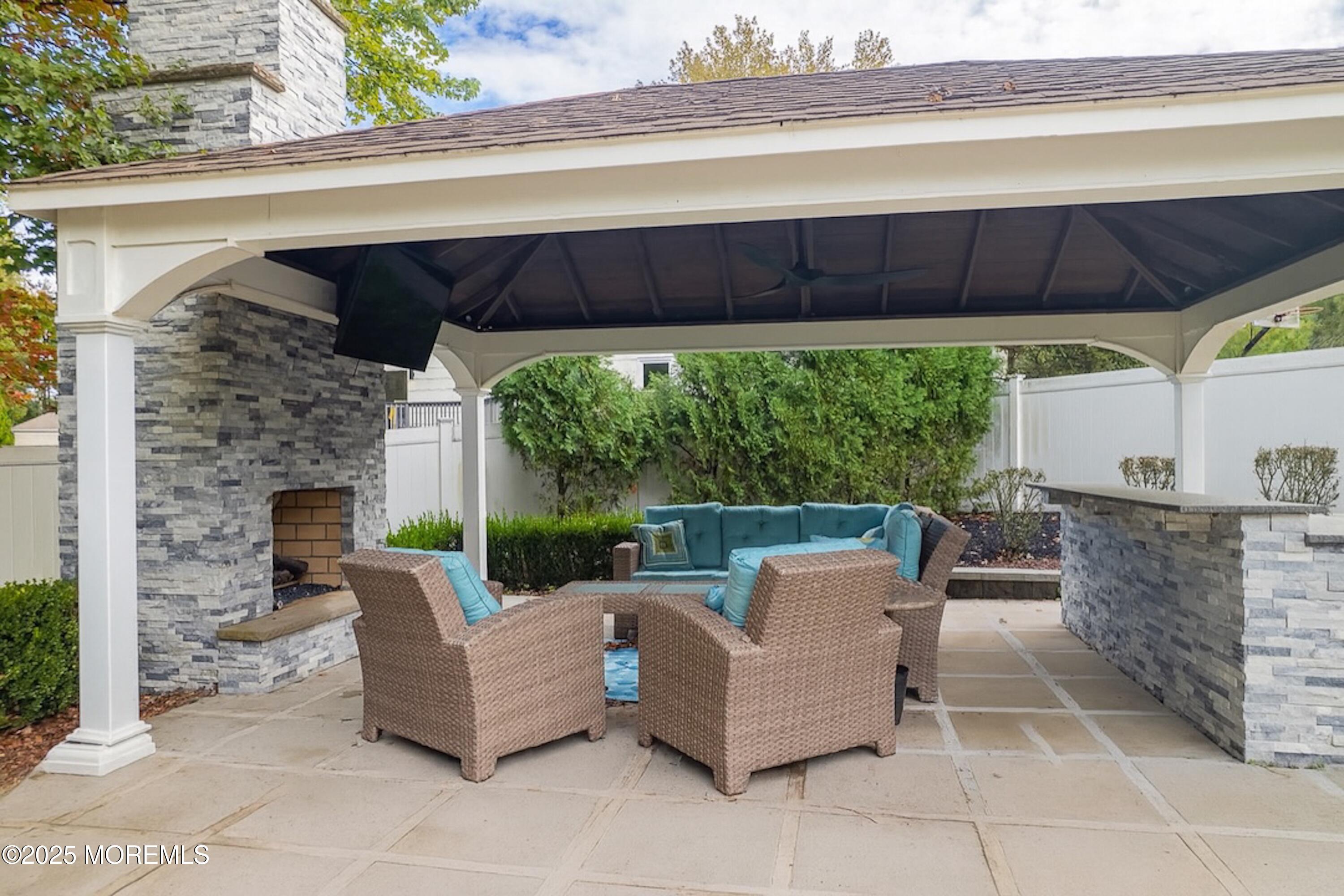 4 Garnet Street Morganville, NJ 07751 - Photo 52 of 70 a view of a patio with table and chairs potted plants with wooden floor