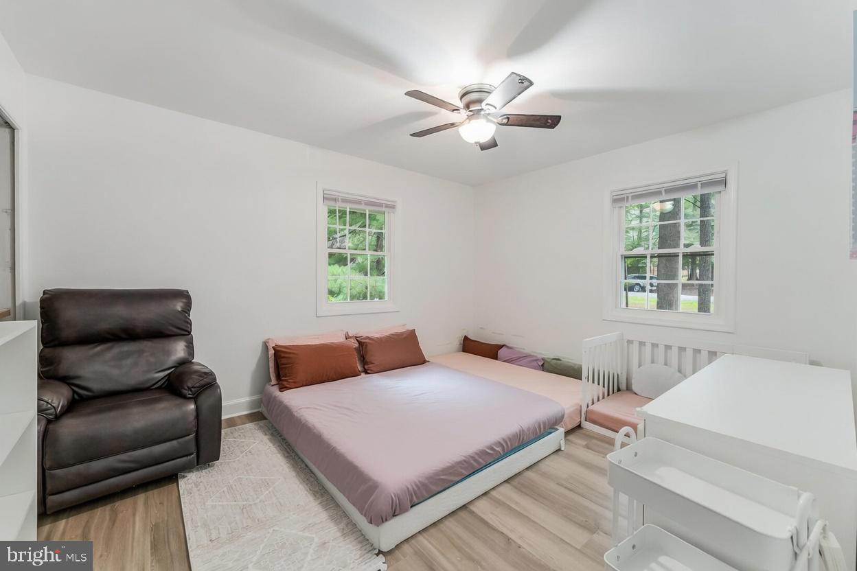 11621 Sourwood Lane Reston, VA 20191 - Photo 10 of 26 a bedroom with a bed and a couch