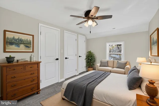 a bedroom with bed and a potted plant