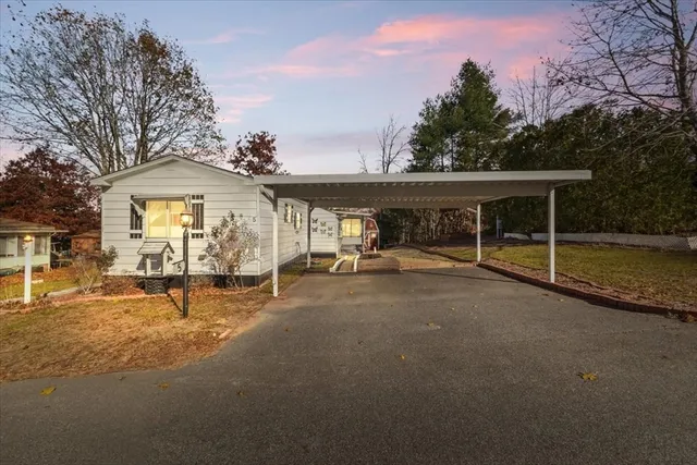 a view of a house with backyard and sitting area