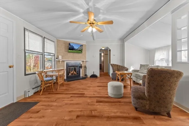 a living room with furniture a fireplace and a flat screen tv