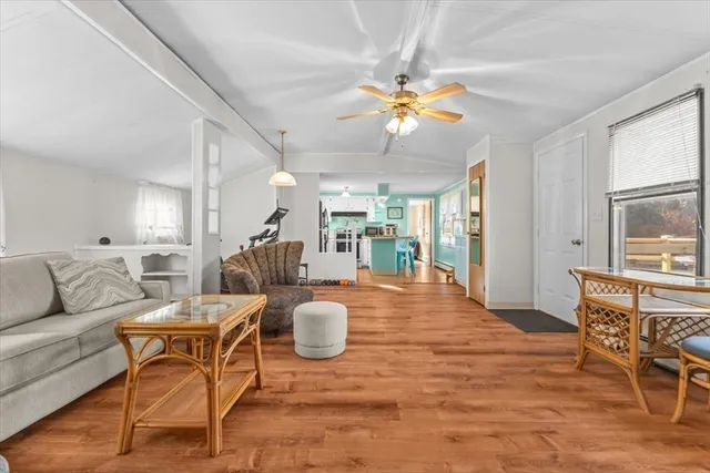a living room with furniture a dining table and a chandelier
