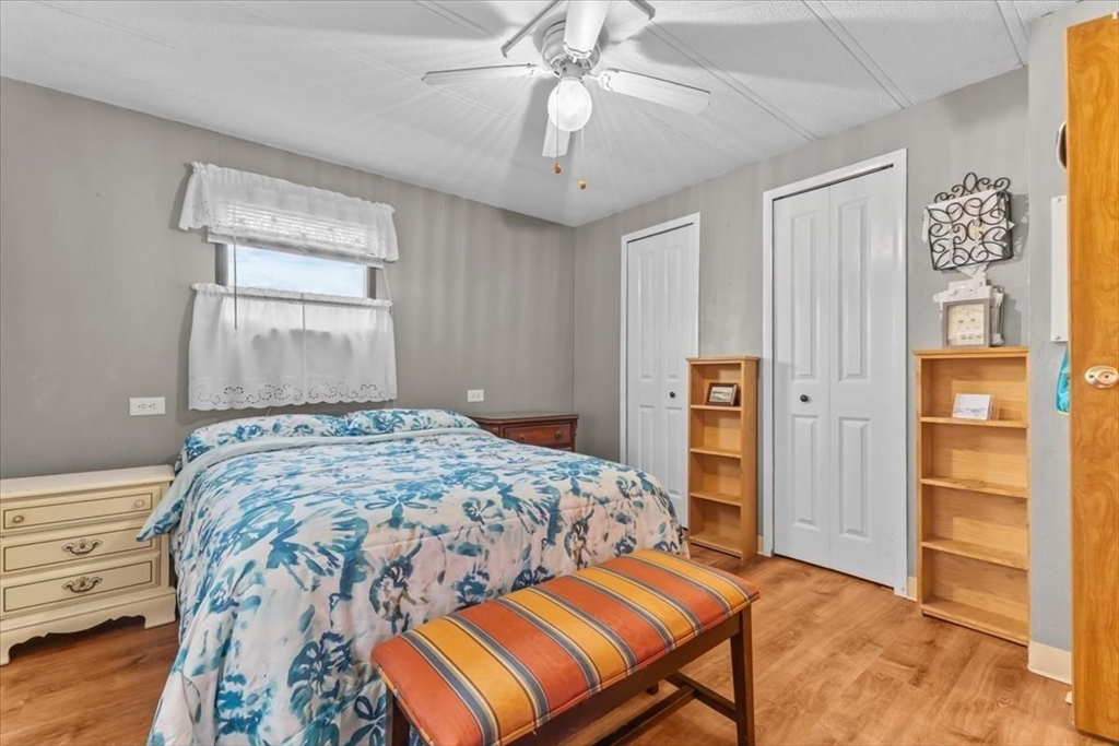 5 Presidents Way Carver, MA 02330 - Photo 18 of 30 a bedroom with a bed and a chandelier
