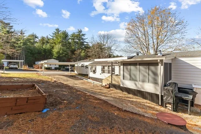 a view of a house with backyard and sitting area