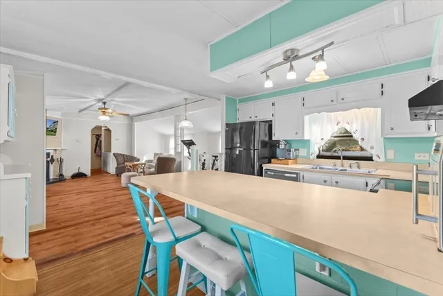 a large kitchen with a table and chairs