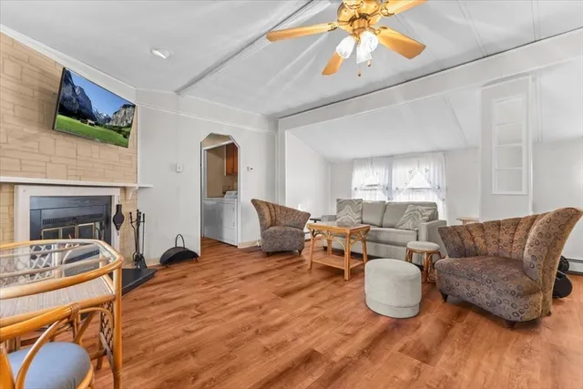a living room with furniture a fireplace and a flat screen tv