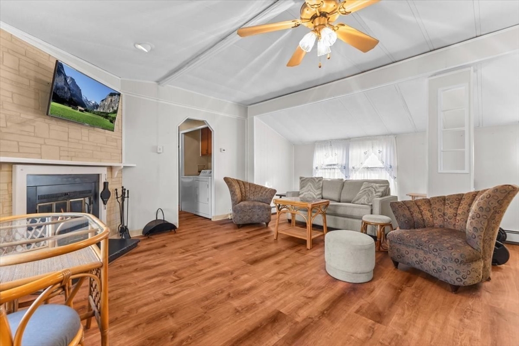 5 Presidents Way Carver, MA 02330 - Photo 10 of 30 a living room with furniture a fireplace and a flat screen tv