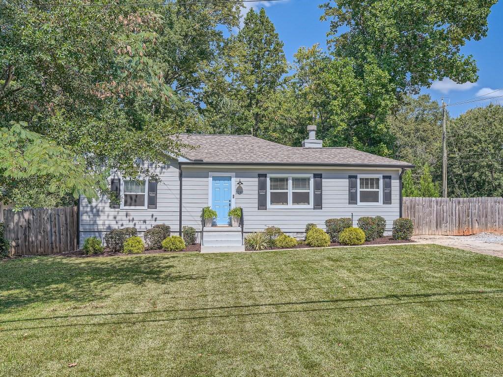 2242 North Shallowford Road Chamblee, GA 30341 - Photo 1 of 1 a front view of house with yard and trees in the background