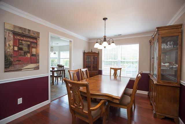 Formal dining with chair rail custom paint and plenty of space for large table and display piece. Easy access to kitchen, living room, and back deck.