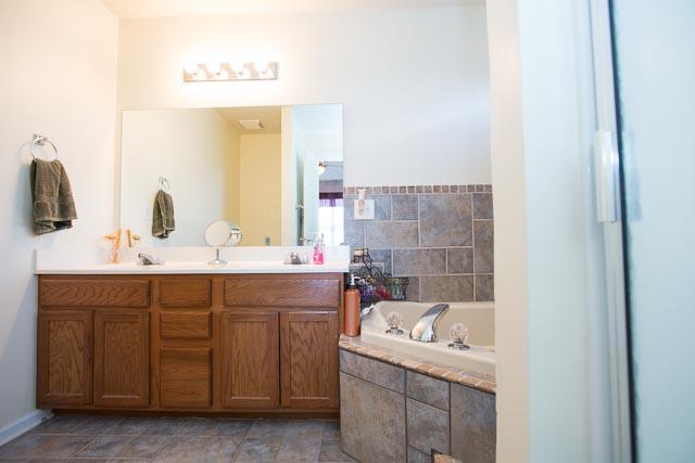 2069 Prescott Way Spring Hill, TN 37174 - Photo 10 of 17 Master Bath has it ALL: Double Vanities, Separate Shower and Jacuzzi Tub, Beautiful Ceramic Tile Floors and accents. This is an excellent space to unwind after a long day.