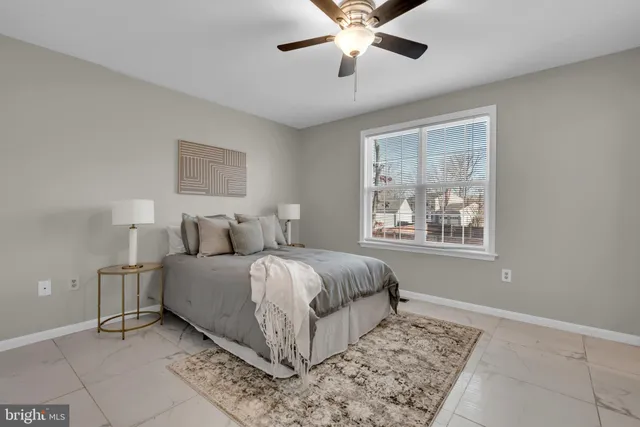 a spacious bedroom with a large bed and a window