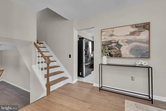 a view of a hallway with wooden floor and workspace