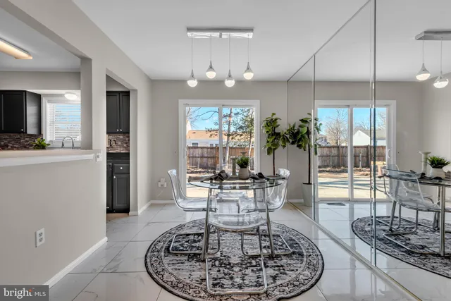 a living room with furniture a dining table and a chandelier
