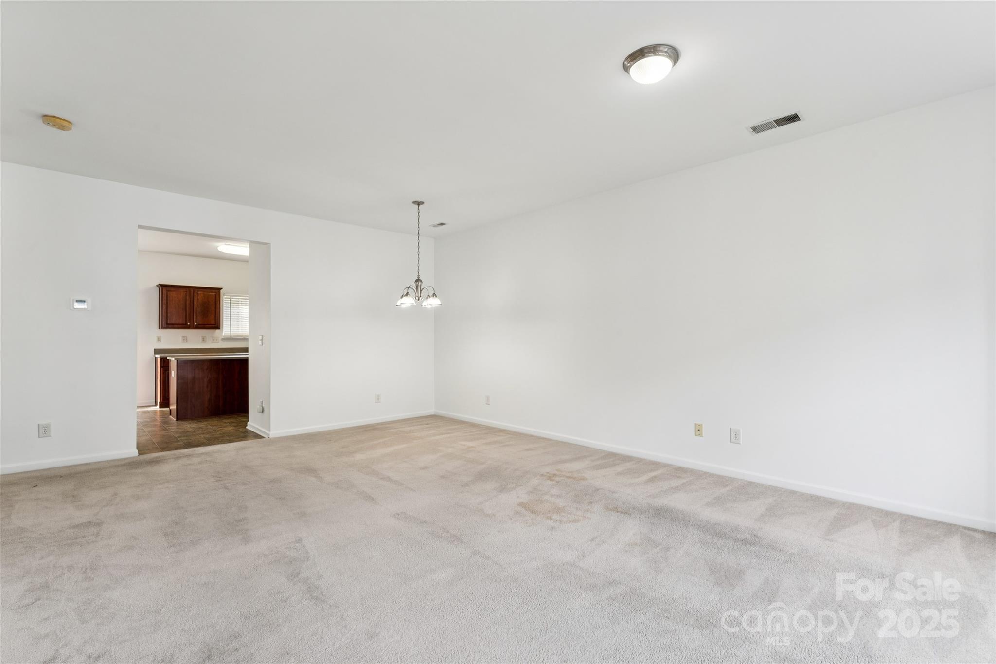 10032 Treeside Lane Matthews, NC 28105 - Photo 16 of 43 an empty room with kitchen and stove