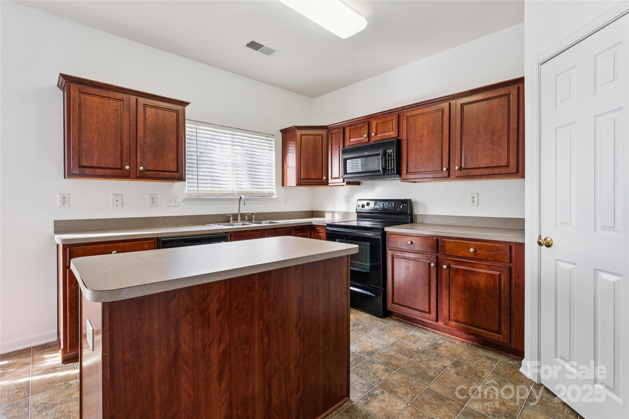 10032 Treeside Lane Matthews, NC 28105 - Photo 18 of 43 a kitchen with stainless steel appliances granite countertop a sink stove and microwave