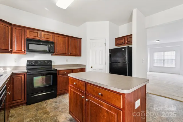 a kitchen with stainless steel appliances granite countertop a stove a sink dishwasher a refrigerator and a microwave oven