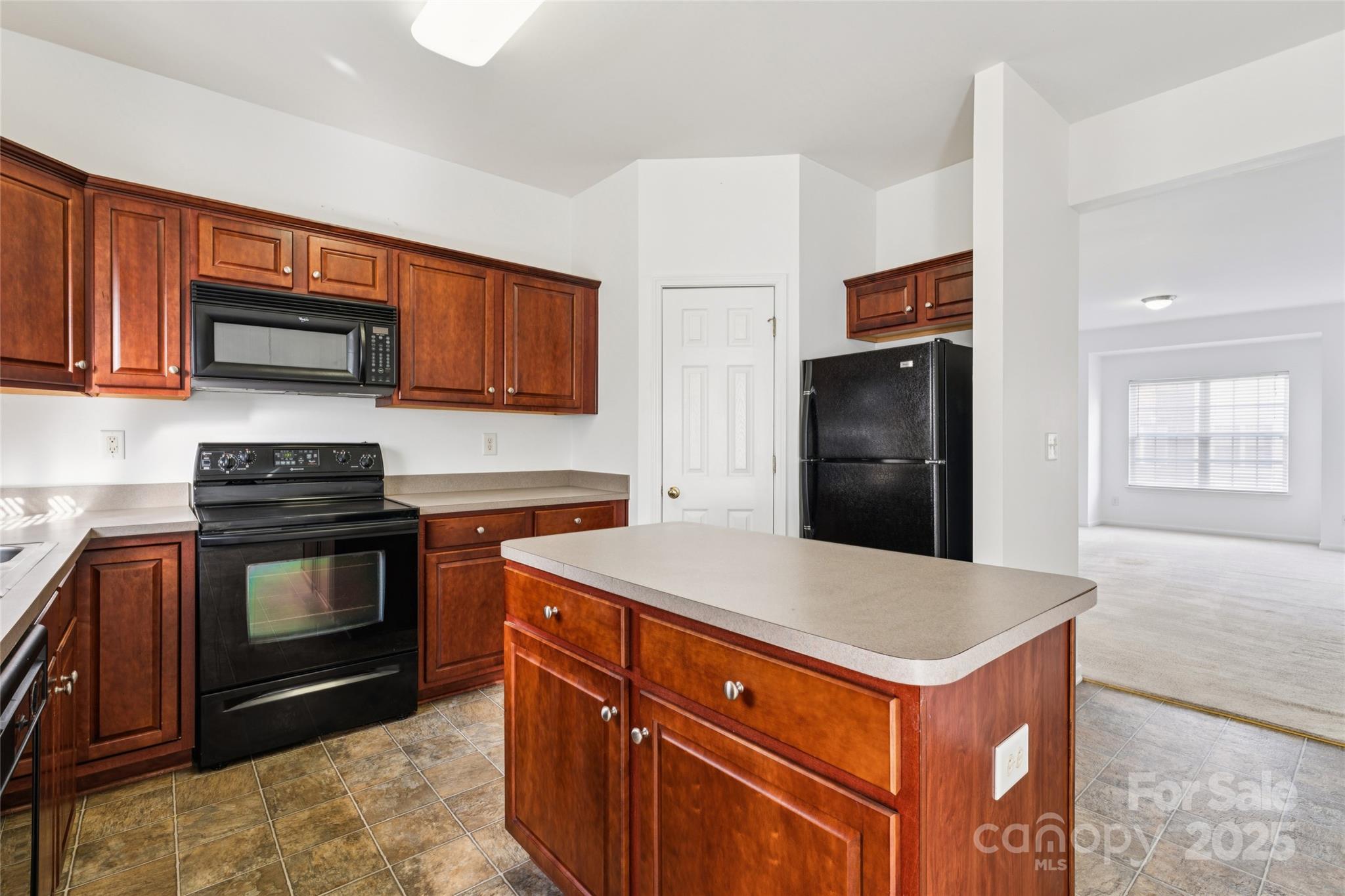 10032 Treeside Lane Matthews, NC 28105 - Photo 21 of 43 a kitchen with stainless steel appliances granite countertop a stove microwave and refrigerator