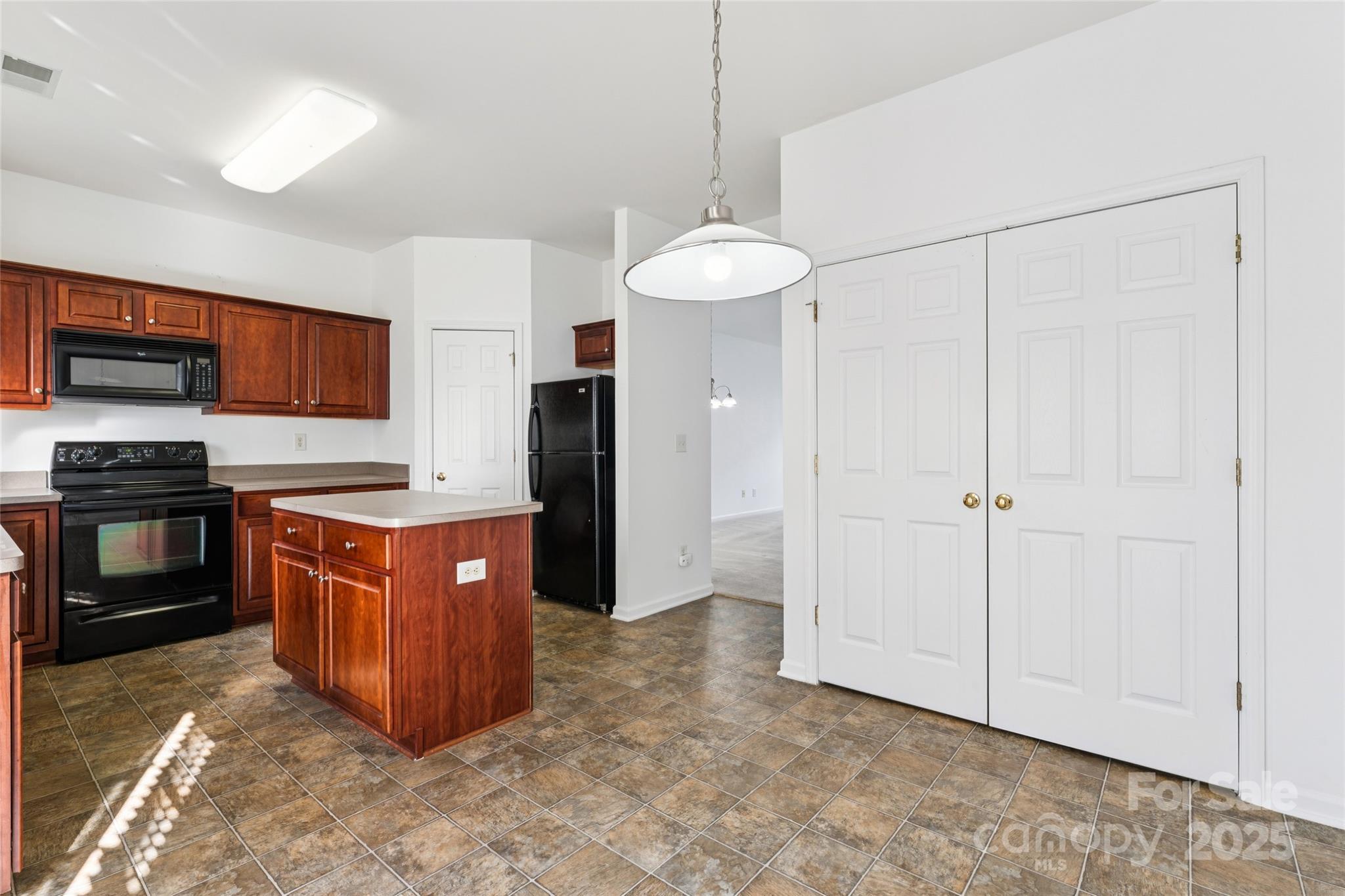10032 Treeside Lane Matthews, NC 28105 - Photo 24 of 43 a kitchen with stainless steel appliances granite countertop a stove a sink and a refrigerator