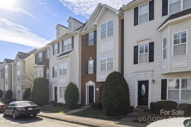 a view of a brick house with a chairs and a table