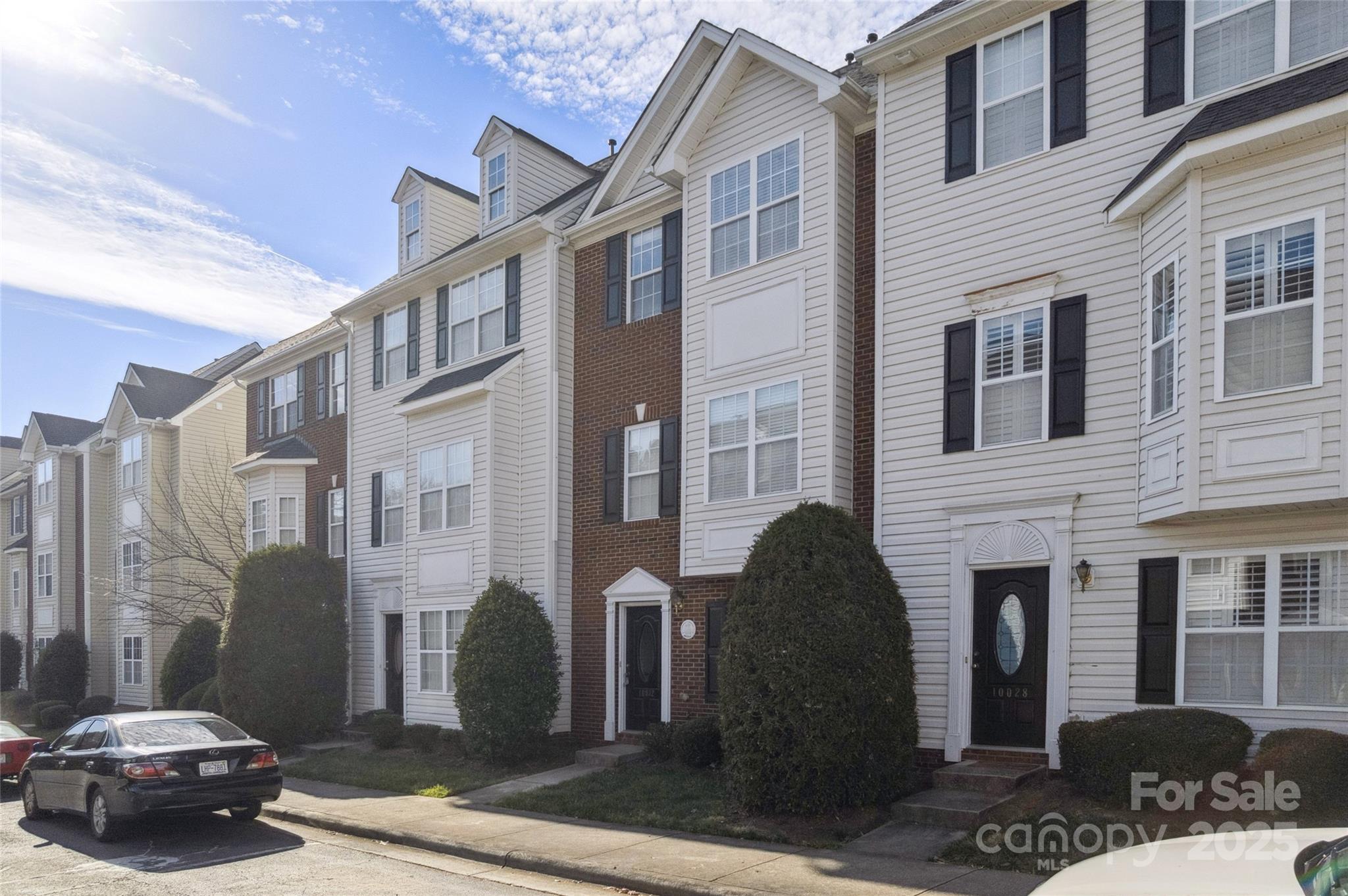 10032 Treeside Lane Matthews, NC 28105 - Photo 3 of 43 a view of a brick house with a chairs and a table