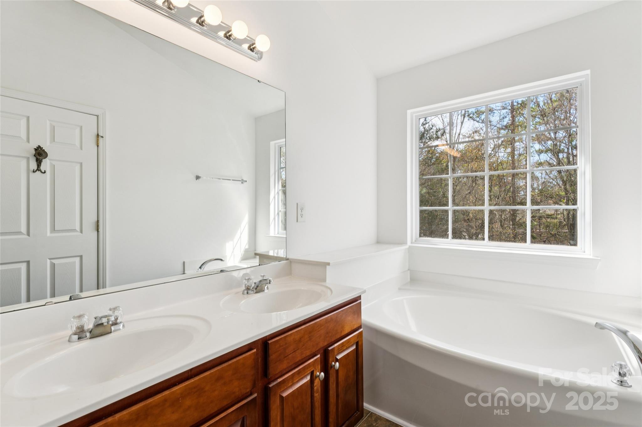 10032 Treeside Lane Matthews, NC 28105 - Photo 32 of 43 a bathroom with a bathtub and a sink