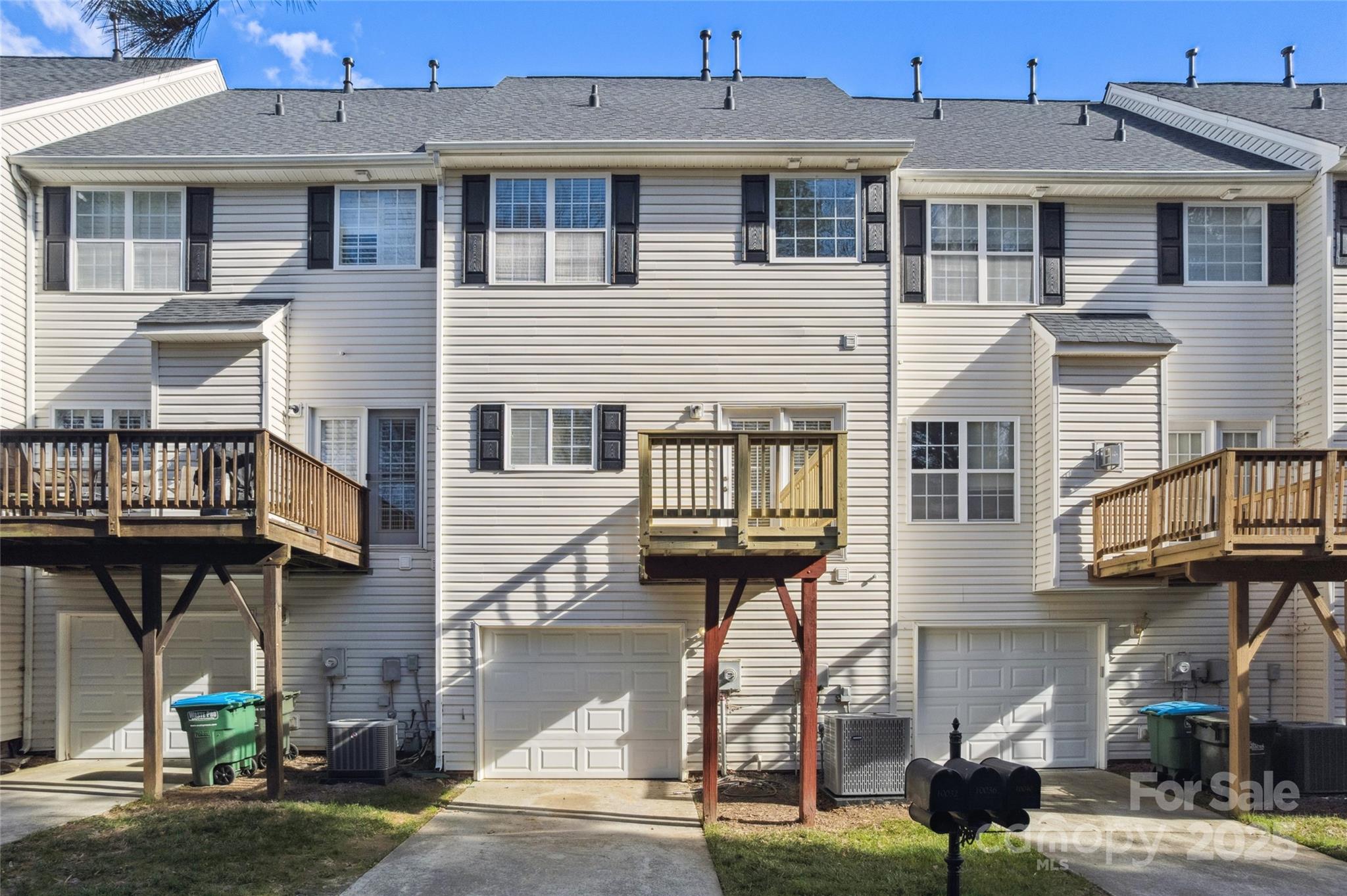 10032 Treeside Lane Matthews, NC 28105 - Photo 38 of 43 a front view of a residential apartment building with a yard