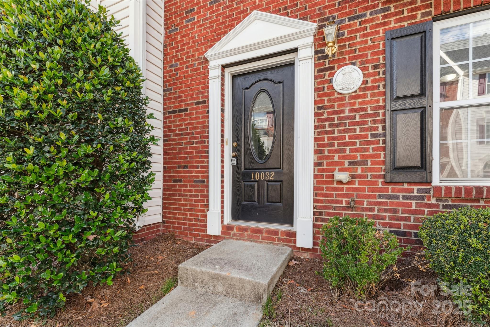 10032 Treeside Lane Matthews, NC 28105 - Photo 5 of 43 a front view of a house with a garden
