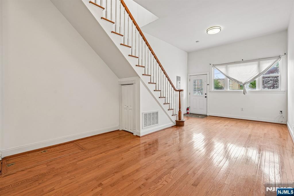 90 A Hackensack Plank Road Weehawken, NJ 07086 - Photo 8 of 40 a view of an empty room with wooden floor and stairs