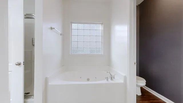 a white bath tub sitting next to a window