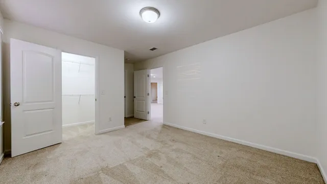 an empty room with closet area