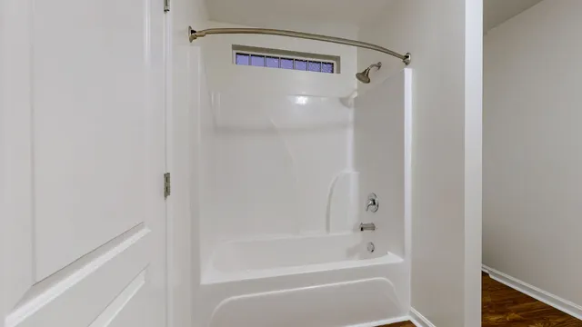 a bathroom with a bathtub and a shower