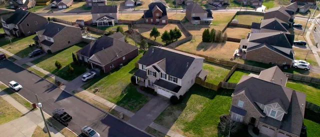 an aerial view of residential houses with outdoor space