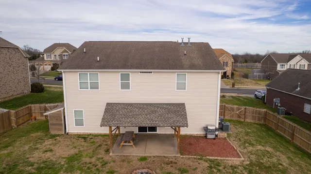 an aerial view of a house with a yard