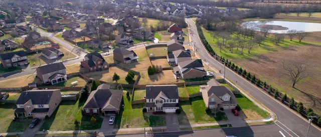 an aerial view of houses with yard