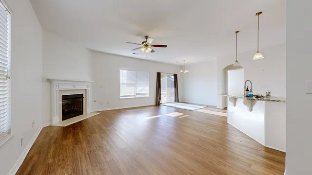 a view of a livingroom with a fireplace and wooden floor