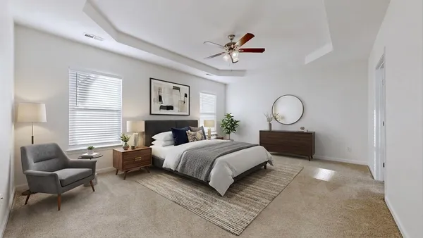 a bedroom with a large bed and wooden floor