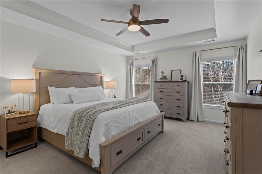 369 Franklin Lane Acworth, GA 30102 - Photo 16 of 27 a spacious bedroom with a bed and a chandelier