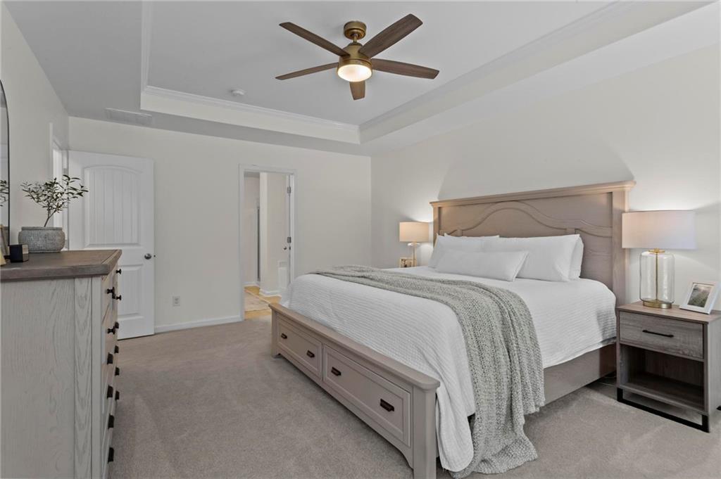 369 Franklin Lane Acworth, GA 30102 - Photo 18 of 27 a spacious bedroom with a bed and a chandelier