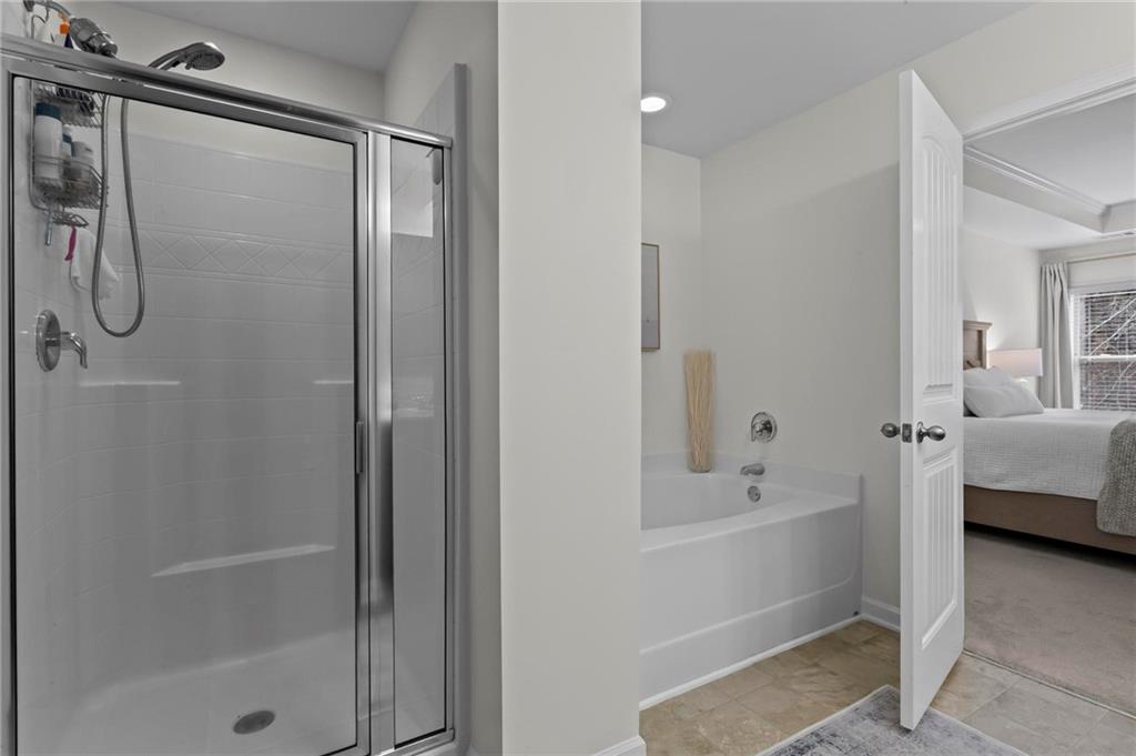 369 Franklin Lane Acworth, GA 30102 - Photo 20 of 27 a bathroom with a bathtub and a shower