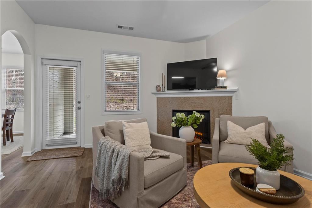 369 Franklin Lane Acworth, GA 30102 - Photo 7 of 27 a living room with furniture a flat screen tv and a fireplace
