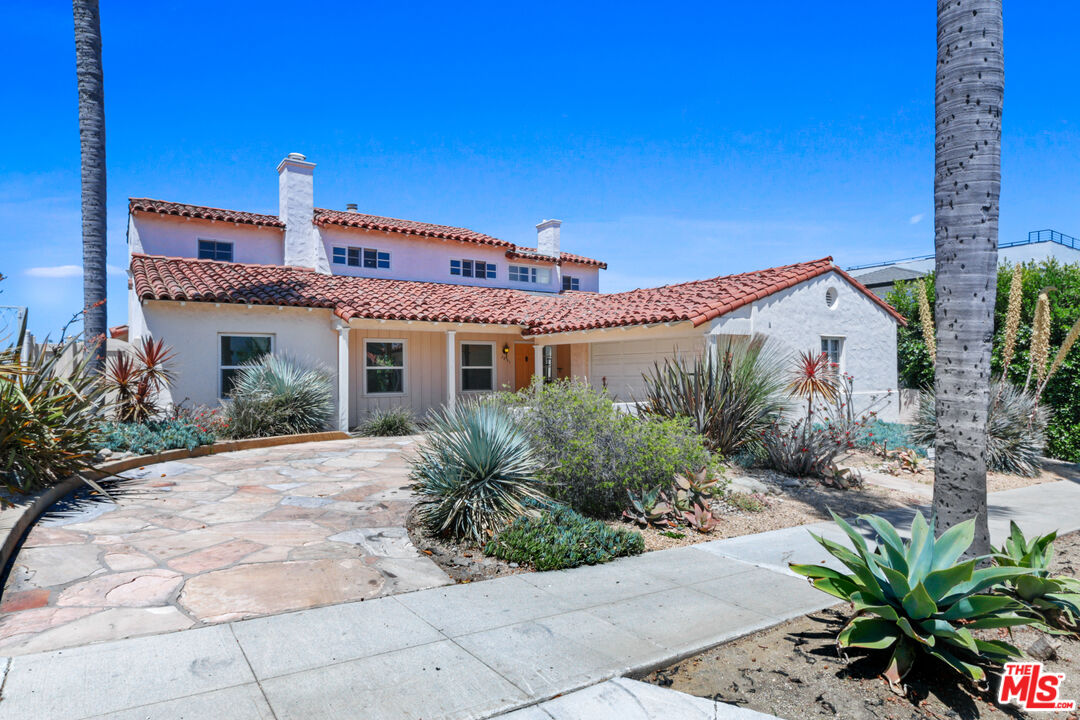 3851 Olympiad Drive View Park, CA 90043 - Photo 2 of 35 a front view of a house with garden