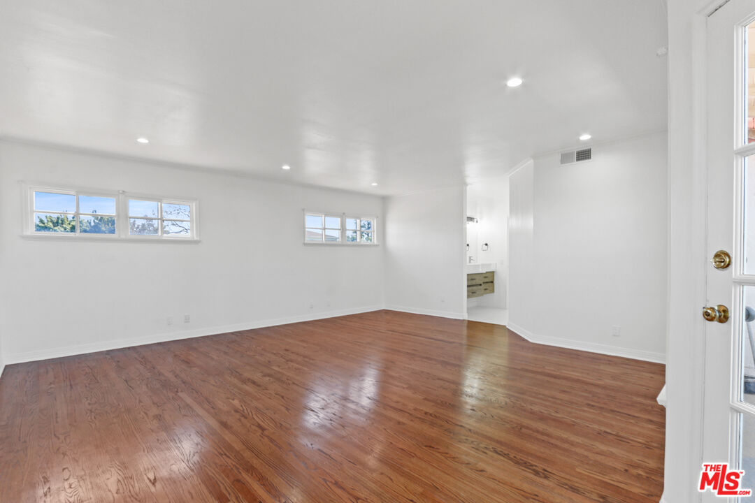 3851 Olympiad Drive View Park, CA 90043 - Photo 24 of 35 a view of an empty room with wooden floor and a window