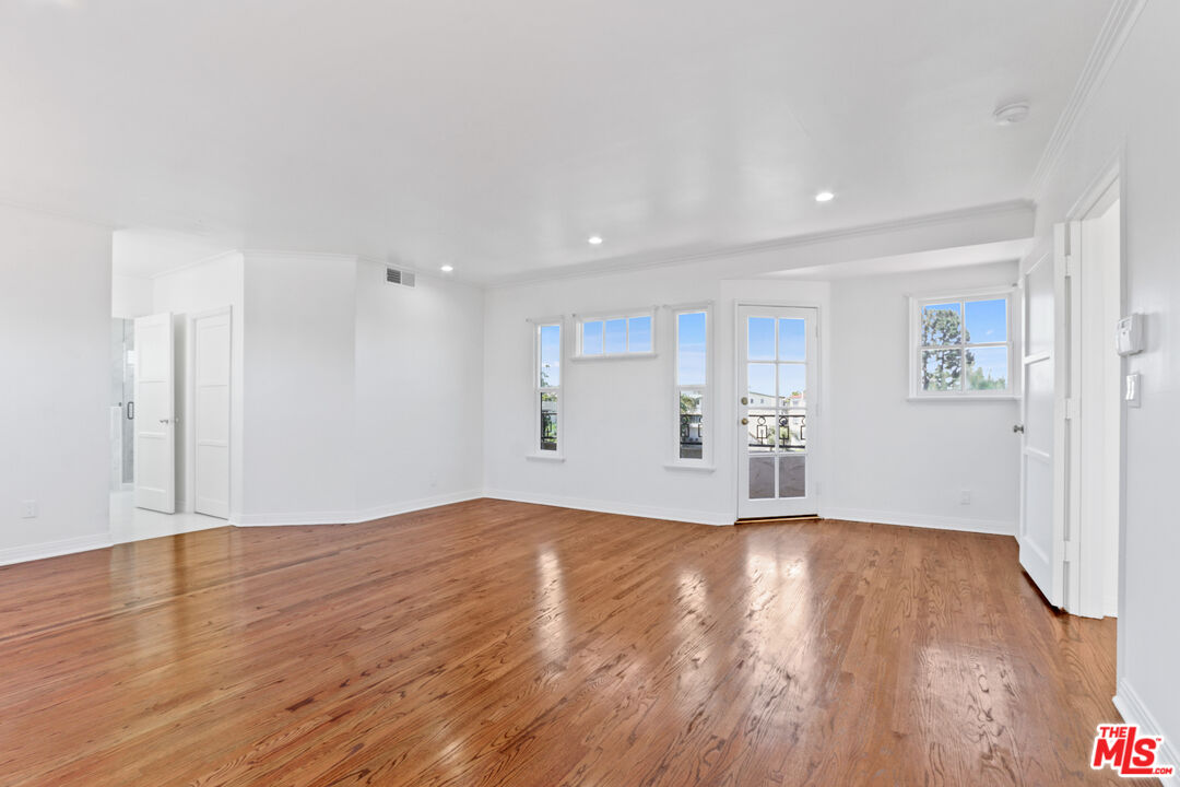3851 Olympiad Drive View Park, CA 90043 - Photo 25 of 35 a view of empty room with wooden floor and window