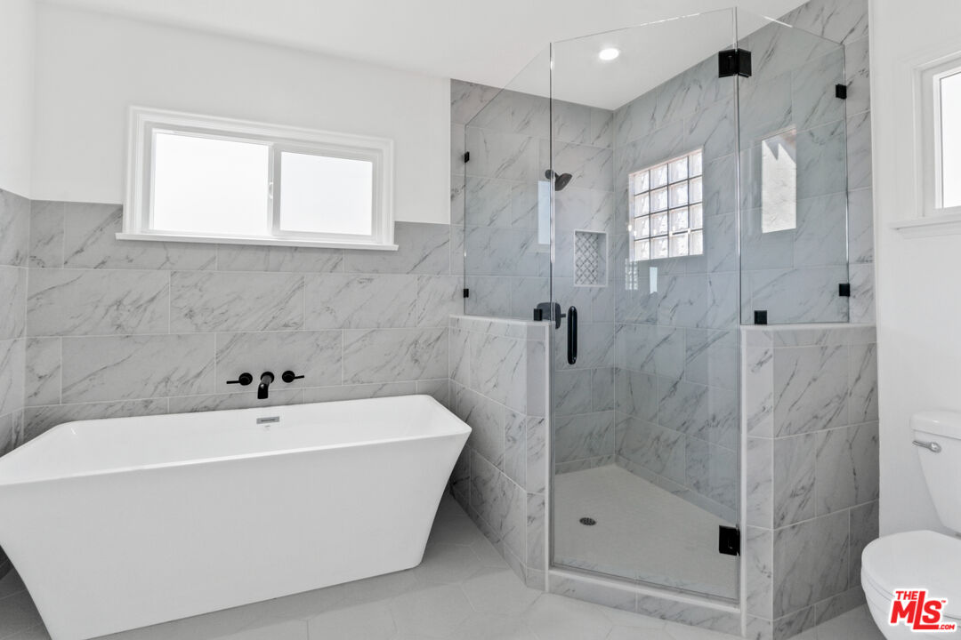 3851 Olympiad Drive View Park, CA 90043 - Photo 29 of 35 a white bath tub sitting next to a shower