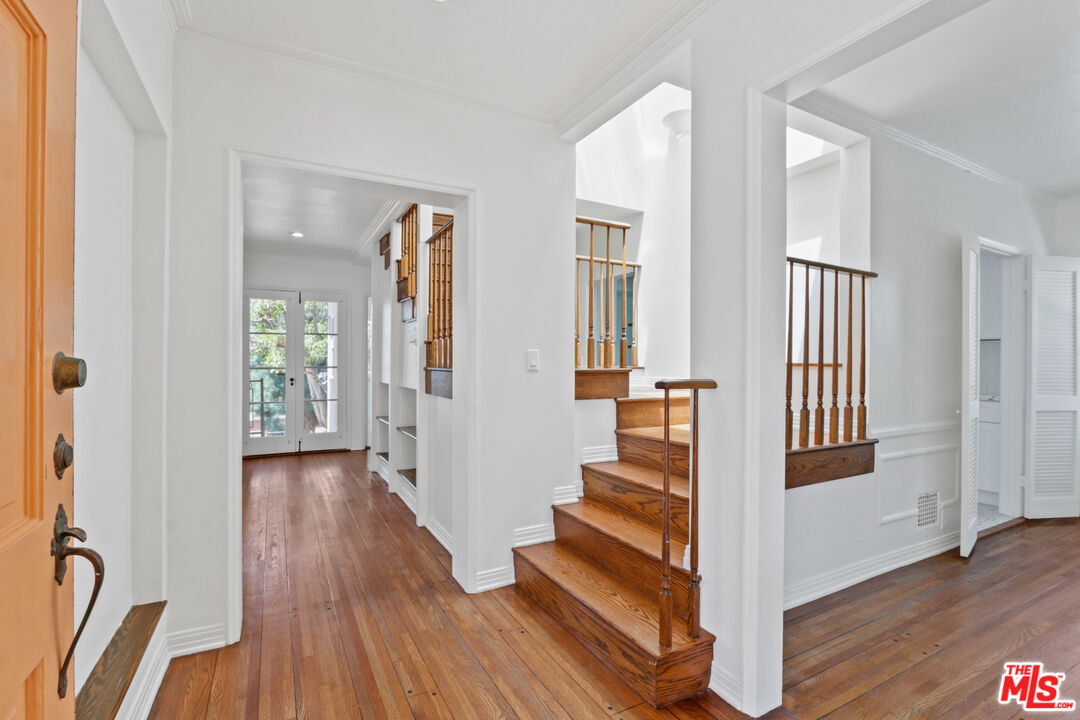 3851 Olympiad Drive View Park, CA 90043 - Photo 3 of 35 a view of entryway with wooden floor and stairs